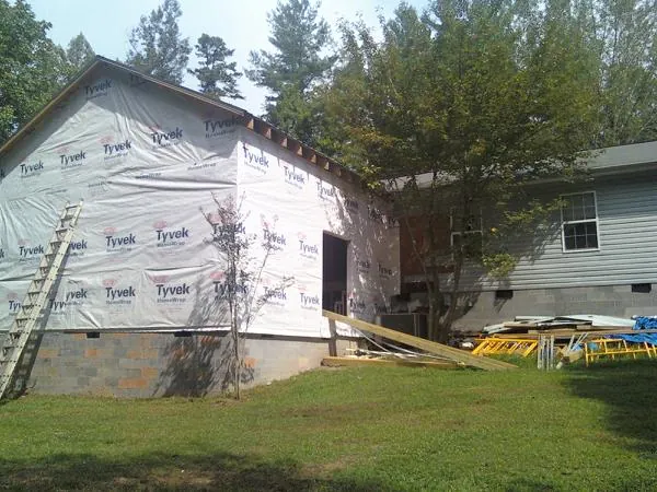 Tyvek wrapped gable on a new room addition beside an existing home in North Liberty